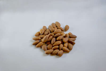 A pile of almonds isolated on light background