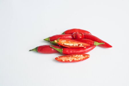 Bright red hot birdseye chili peppers on white background