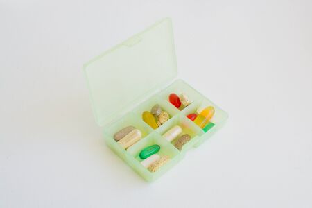 Different medicine tablets in a pill box on white backgroundの写真素材