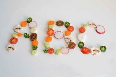 ABC spelled out from vegetable slices on a white backgroundの写真素材