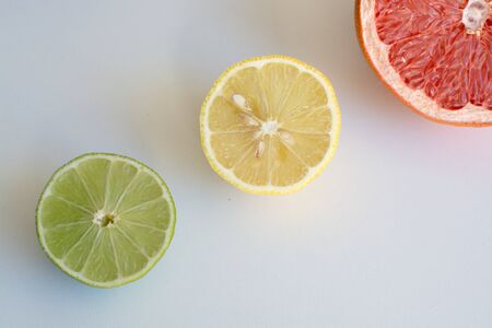 Sliced lime, lemon and grapefruit on a light background