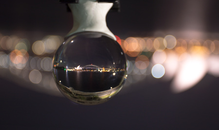Night time view of Sydney harbour bridge and surrounds reflecting in a crystal ballのeditorial素材