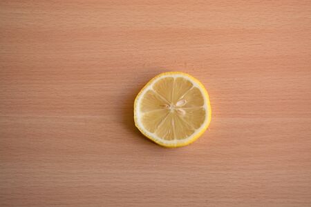 One slice of lemon on a wooden backgroundの写真素材