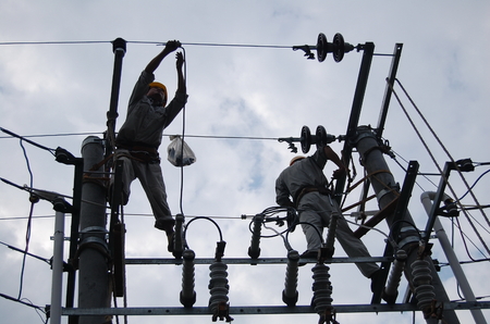 Technicians working at the power poleのeditorial素材