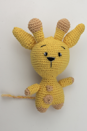 yellow yarn rabbit on white backgrundの写真素材