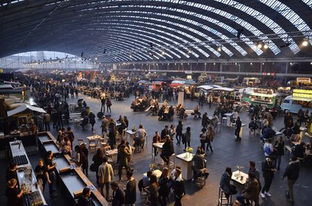 Amsterdam, the Netherlands - November 29, 2015: High view of the crowd at the bar in front of food trucks in the Europe Complex Europahal at the Foodfestival Amsterdam 2015 at the RAIのeditorial素材