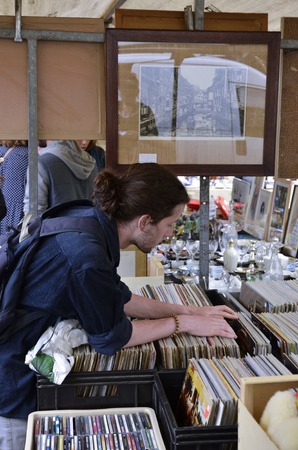 Amsterdam, Netherlands - May 21, 2016: Young man browsing the record collection at the weekend flee market at the Northern Market (Noordermarkt), in the Jordaan district.のeditorial素材