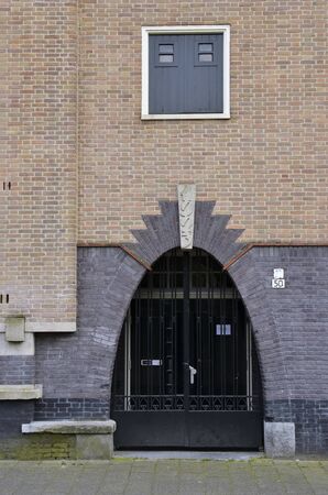 Amsterdam, Netherlands - May 21, 2016: Elliptic shape grid entrance gate of a residential building, in Amsterdam School architecture style, in the Spaarndammerbuurt district.のeditorial素材
