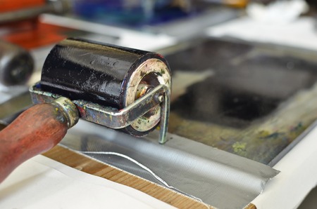 An ink roll covered with black ink used for a manual letterpress print machineの写真素材
