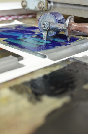 An ink roll covered with purple ink used for a manual letterpress print machineの写真素材