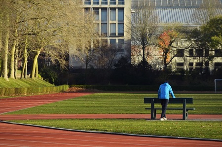 Brussels, Belgium - November 29, 2016: The back of a runner on the running track in the north-east...