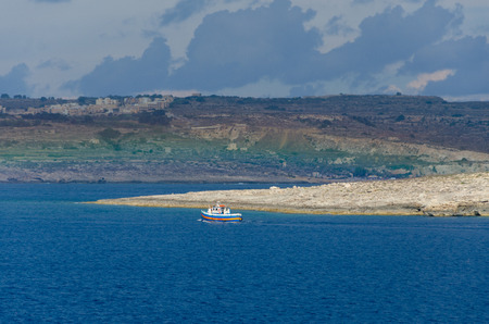 Comino island located in the channel between Malta and Gozo and rainbowの写真素材