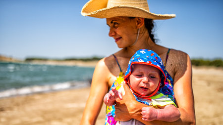 A mother with her baby on the beach.の写真素材