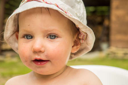 Portrait of an adorable little girl playing in the garden.の写真素材