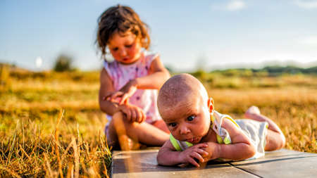 Siblings playing on the beachの写真素材