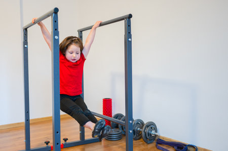 A four-year-old girl training in a home gym.の写真素材