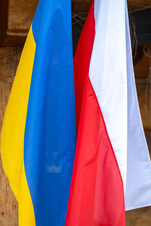 The flag of Poland and Ukraine waving together as a symbol of opposition to Russian aggression.の写真素材