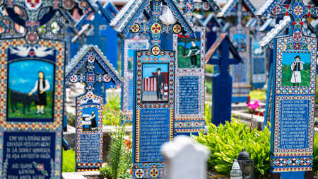 Sapanta, Maramures, Romania - June 17, 2022: Painted blue wooden monuments in an unique in the World "Merry Cemetery".のeditorial素材