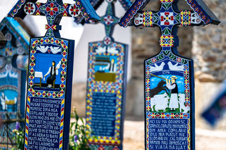 Sapanta, Maramures, Romania - June 17, 2022: Painted blue wooden monuments in an unique in the World "Merry Cemetery".のeditorial素材
