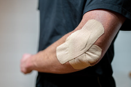Tennis elbow taped with elastic therapeutic at orthopedic ward close up image. Physiotherapy...
