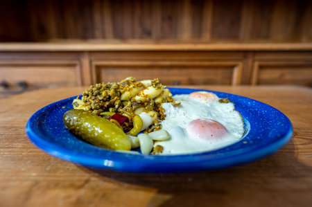 Healthy and delicious homemade dinner in a plate. Fried eggs, vegetables and pulses dal.の写真素材