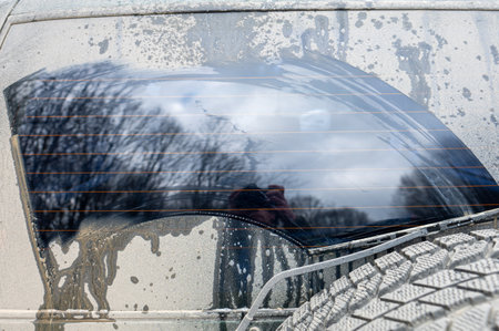 Dirty car rear window. Adventure background. Detail of dirty off-road carの写真素材