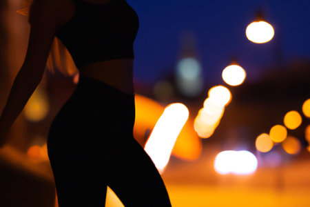 Blurred background with a silhouette of an attractive young woman standing in the street.の素材