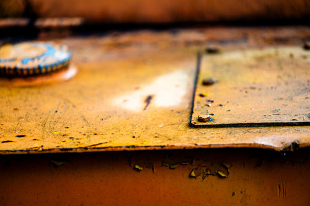 Authentic old style industrial background. Close-up of a dirty part of an old road roller. Orange...