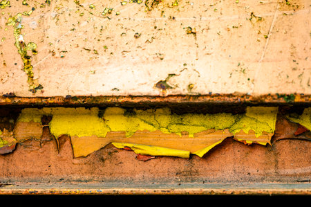 Authentic old style industrial background. Close-up of a dirty part of an old road roller. Orange colored metal.の写真素材