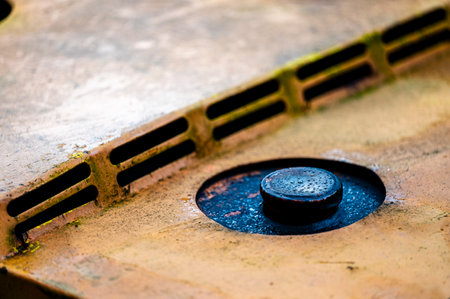 Authentic old style industrial background. Close-up of a dirty part of an old road roller. Orange colored metal.の写真素材
