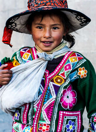 Peruvian girl in traditional dress a posing for a photo in Cusco , Peru,           South America.のeditorial素材