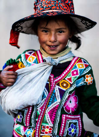 Peruvian girl in traditional dress a posing for a photo in Cusco , Peru,           South America.のeditorial素材