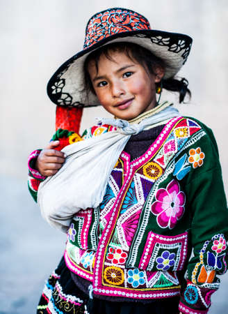 Peruvian girl in traditional dress a posing for a photo in Cusco , Peru,           South America.のeditorial素材
