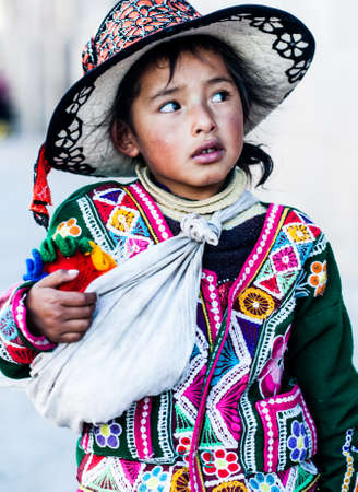 Peruvian girl in traditional dress a posing for a photo in Cusco , Peru,           South America.のeditorial素材