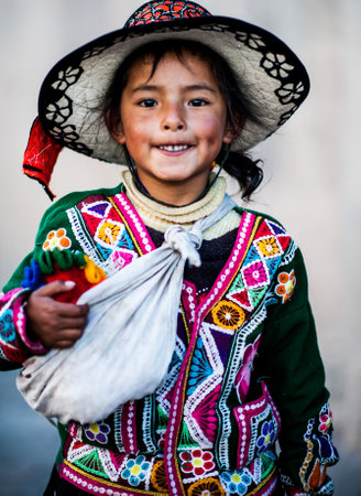 Peruvian girl in traditional dress a posing for a photo in Cusco , Peru,           South America.のeditorial素材