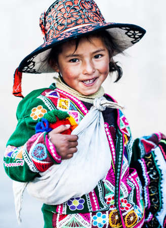 Peruvian girl in traditional dress a posing for a photo in Cusco , Peru,           South America.のeditorial素材