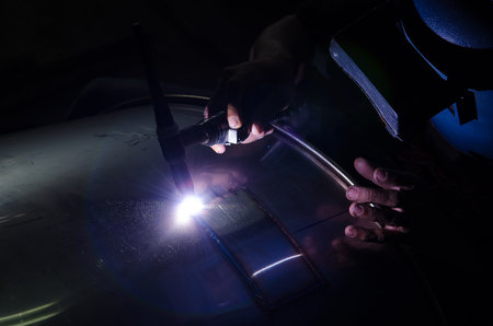 Stainless steel welder in small factory with lens flare styleの写真素材