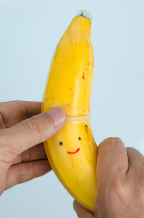 Put on condom with banana for birth controlの写真素材