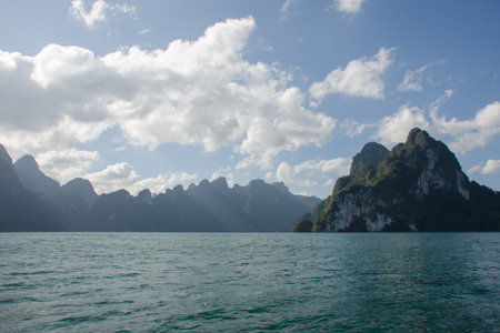 Beautiful mountains behind fog in Ratchaprapha Dam at Khao Sok National Park, Surat Thani Province,...