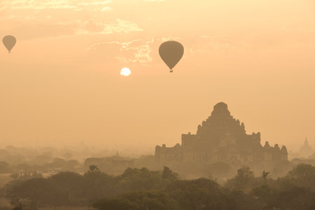 Dhammayangyi temple The biggest Temple in Bagan with balloons and sunrise, Myanmarの写真素材