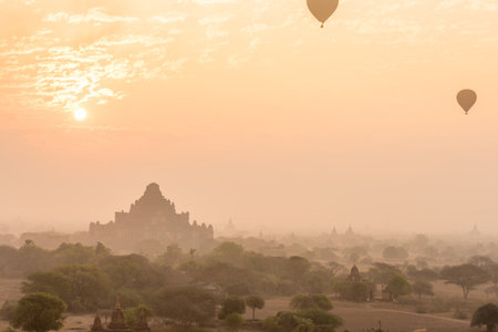 Dhammayangyi temple The biggest Temple in Bagan with hot air balloons and sunrise, Myanmarの写真素材