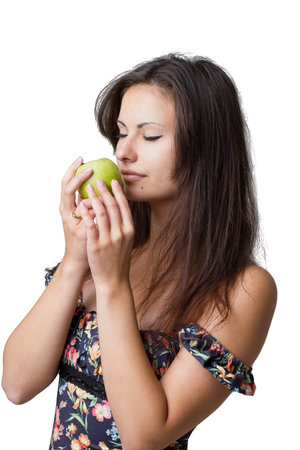 Girl with apple isolated on white backgroundの写真素材