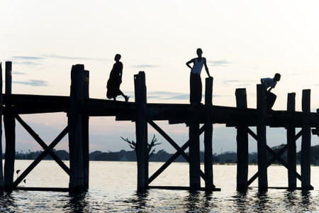 Burmese people at sunset at U Bein bridgeの写真素材