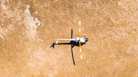 a passenger helicopter will land and stand in the middle of the desert, top view