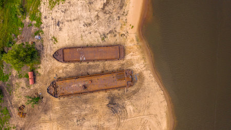 abandoned boat graveyard, barges rusting on the river bankの写真素材