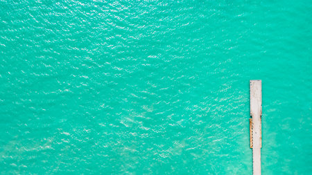 mesmerizing aerial view of the long jetty, which stands in a turquoise sea, aerial view on a clear dayの写真素材