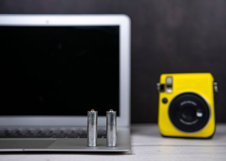 two batteries are on the laptop, the camera has run out of battery powerの写真素材