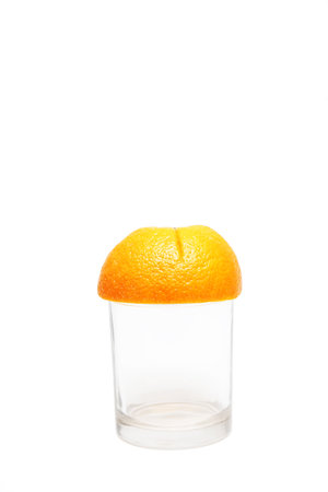 Sliced orange fruit on empty glassの写真素材