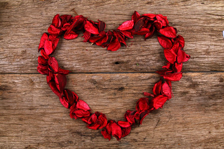 Heart made from red potpourri flower petalsの写真素材