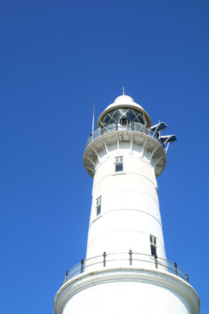 White lighthouse with blue sky backgrondの写真素材